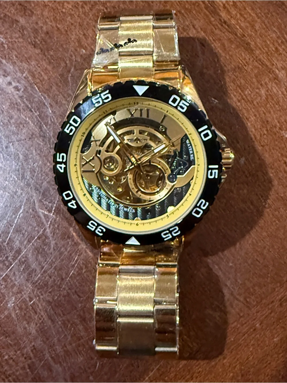 Men's Gold Skeleton Automatic Watch with Black Bezel